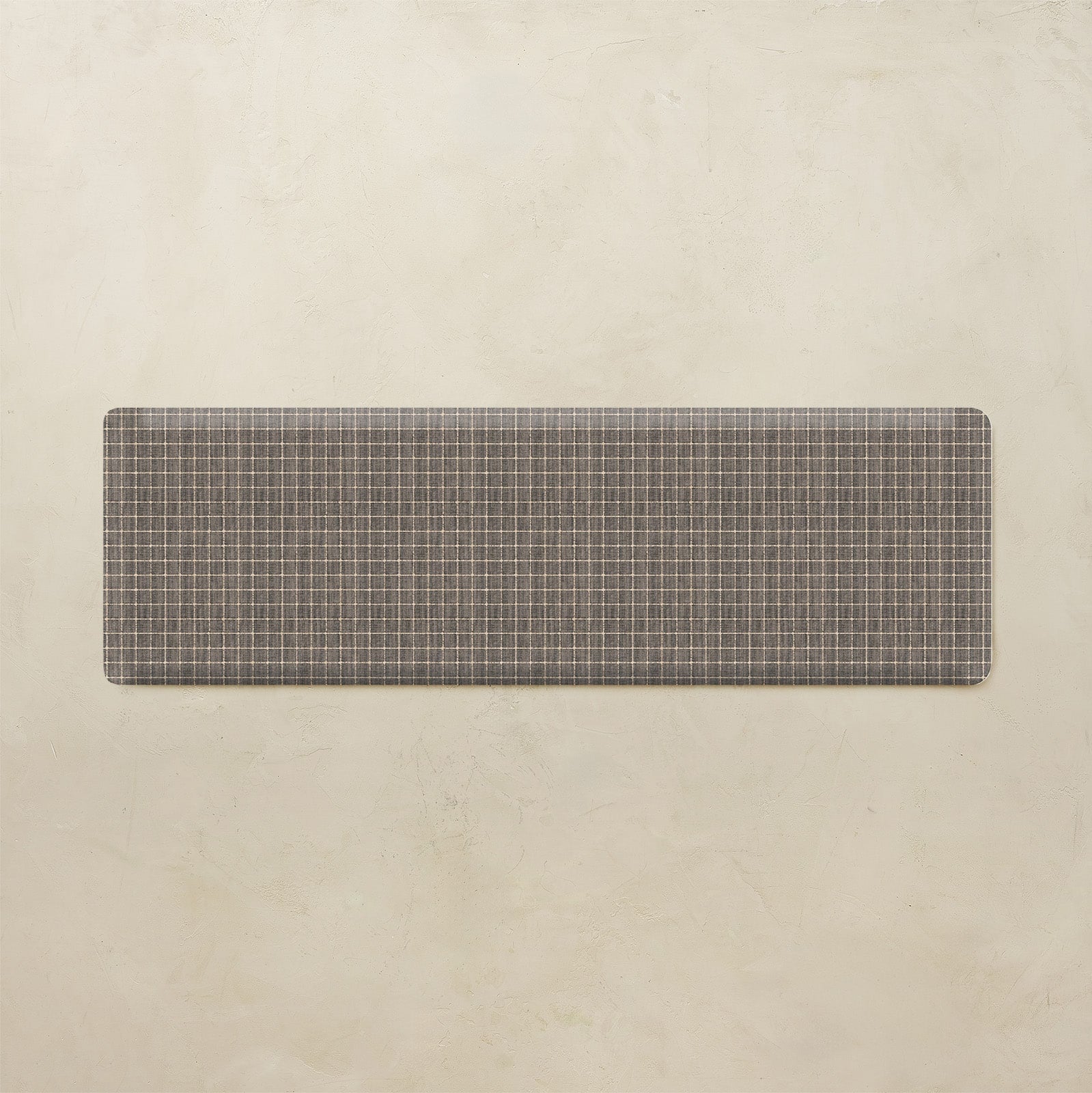 Rectangular mat with grid pattern on a beige background