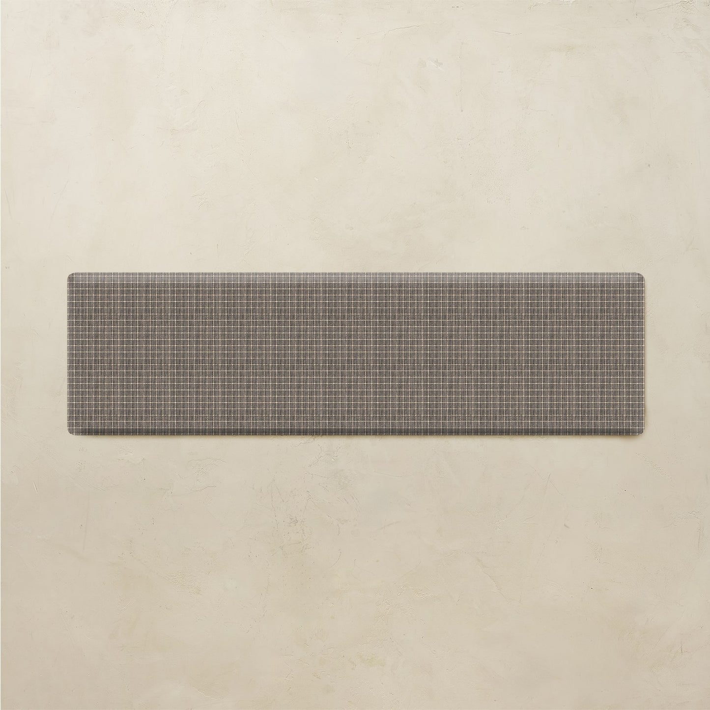 Rectangular grid kitchen mat on a beige background