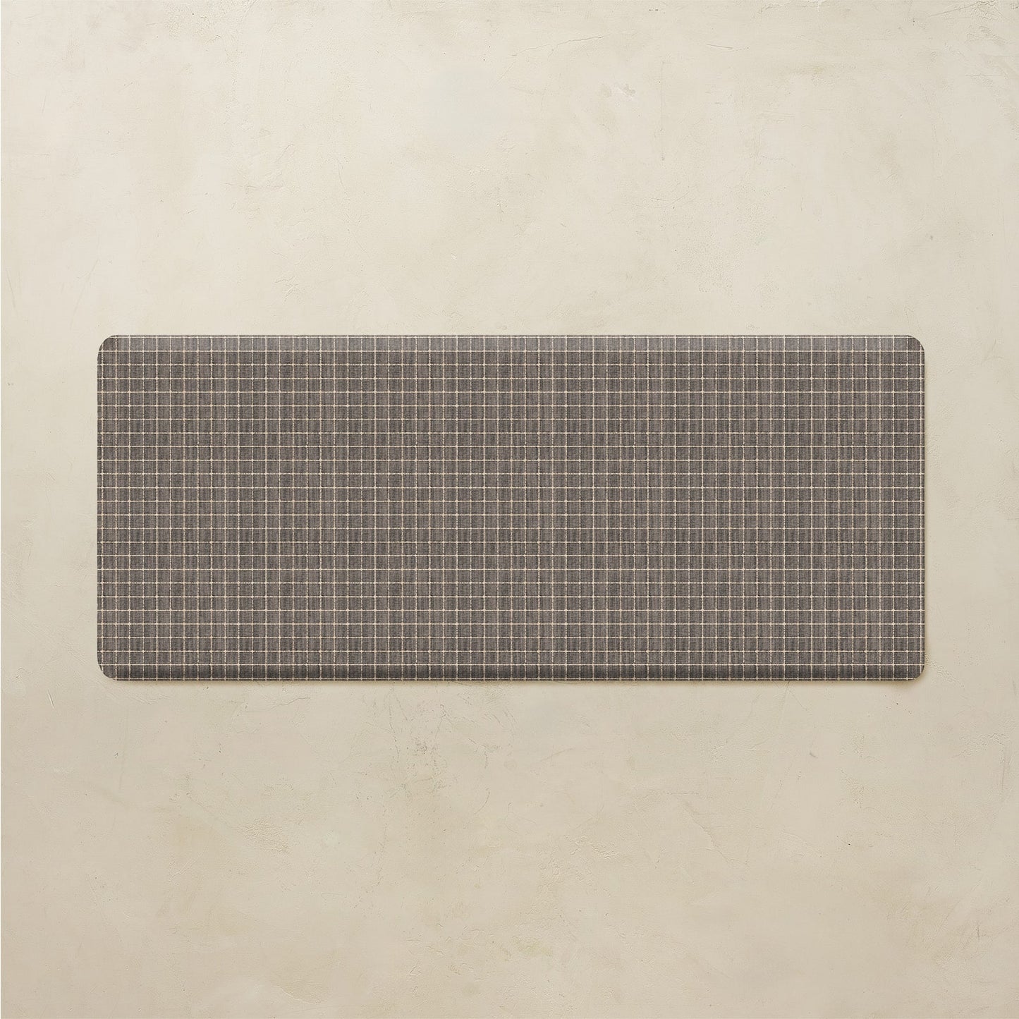 Rectangular grid pattern kitchen mat on a beige background