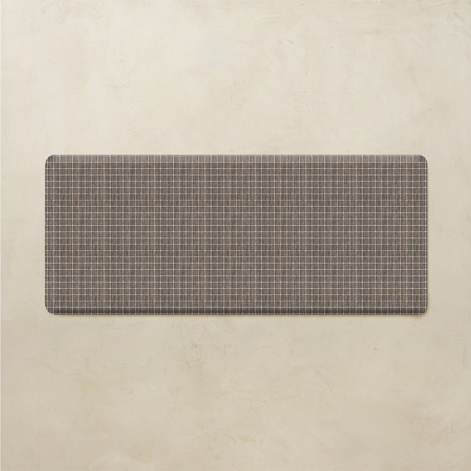 Rectangular grid pattern kitchen mat on a beige background