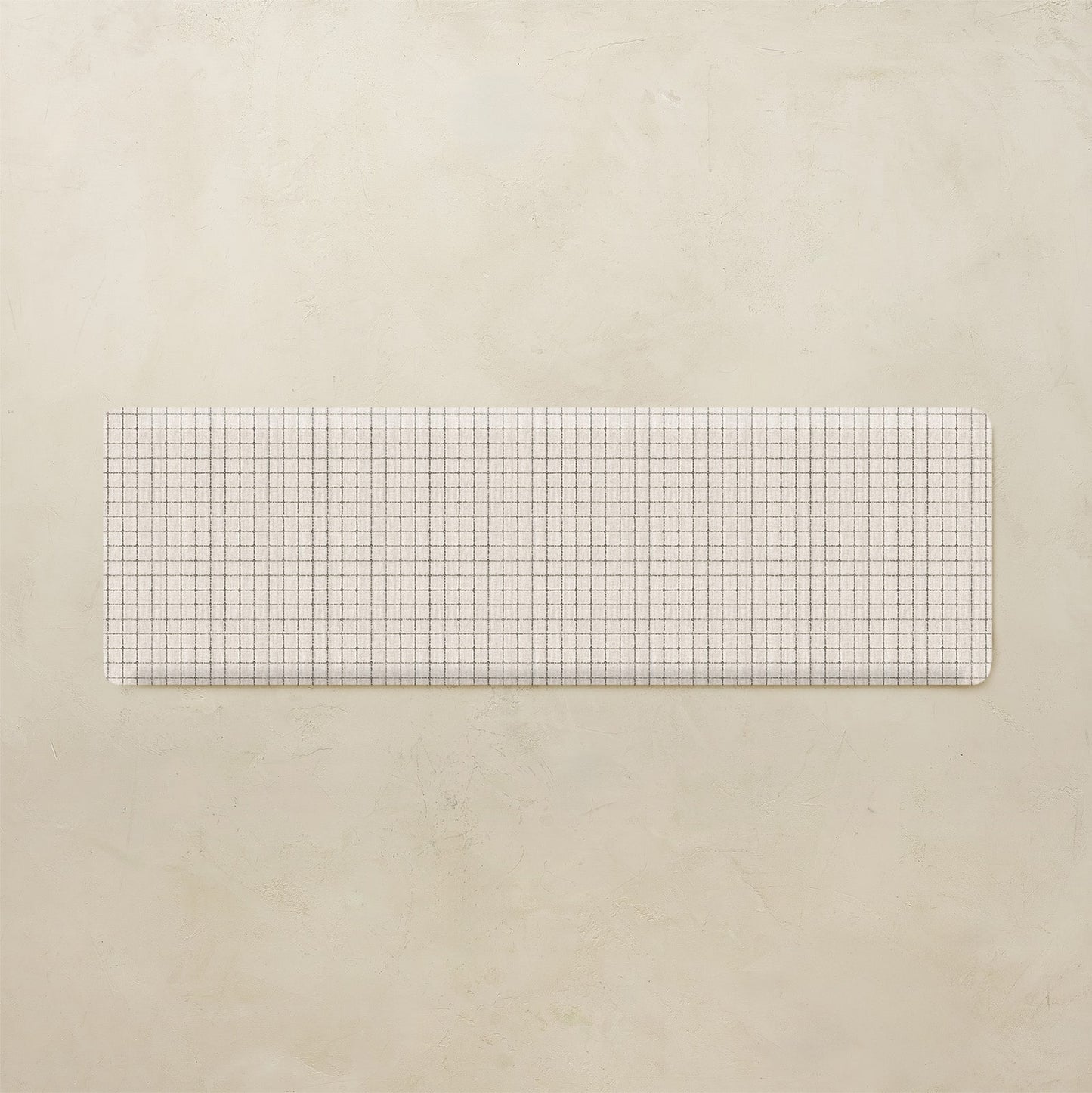 Rectangular grid kitchen mat on a beige background