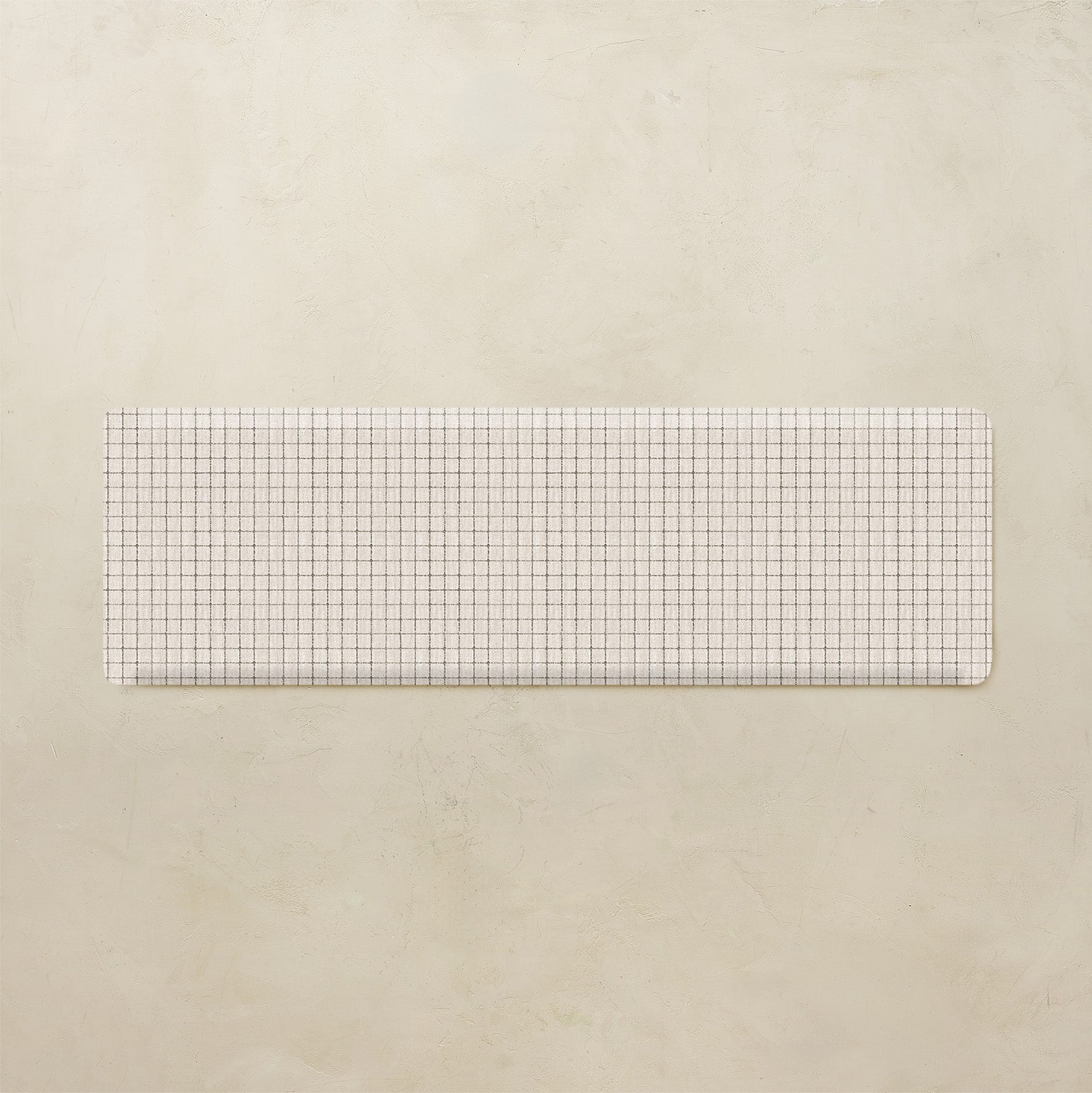 Rectangular grid kitchen mat on a beige background