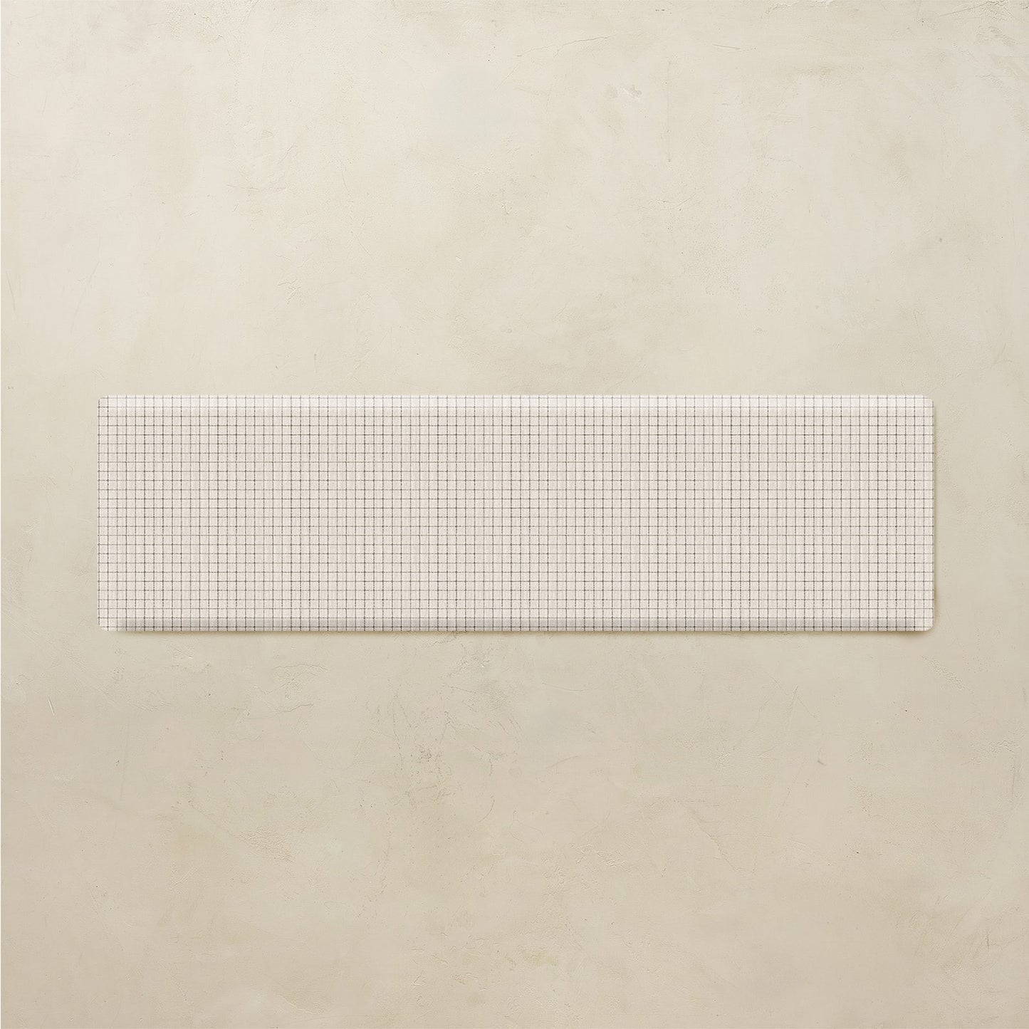 Rectangular white grid kitchen mat on a beige background