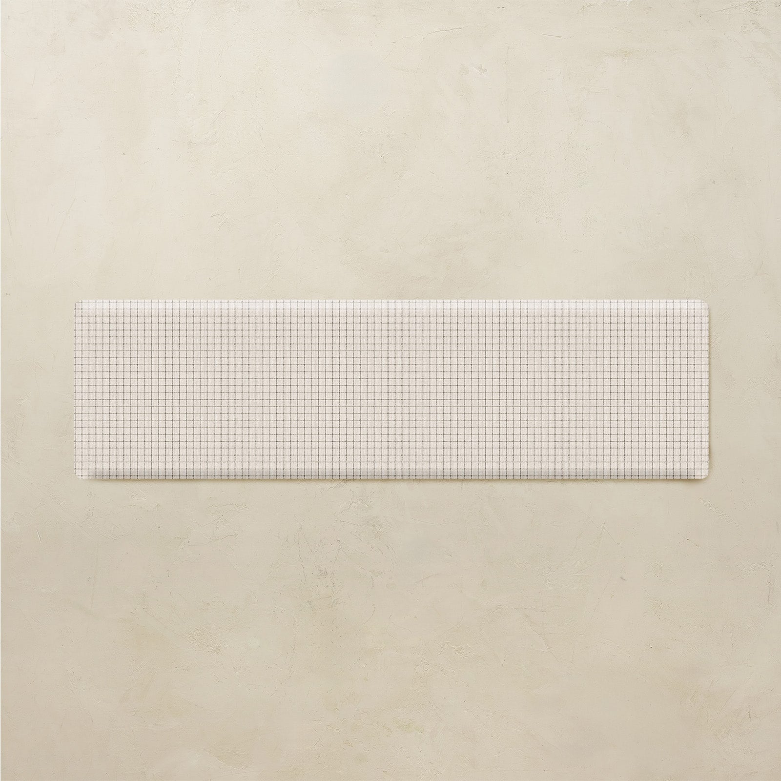 Rectangular white grid kitchen mat on a beige background