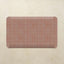 Rectangular kitchen mat with grid pattern on a beige background
