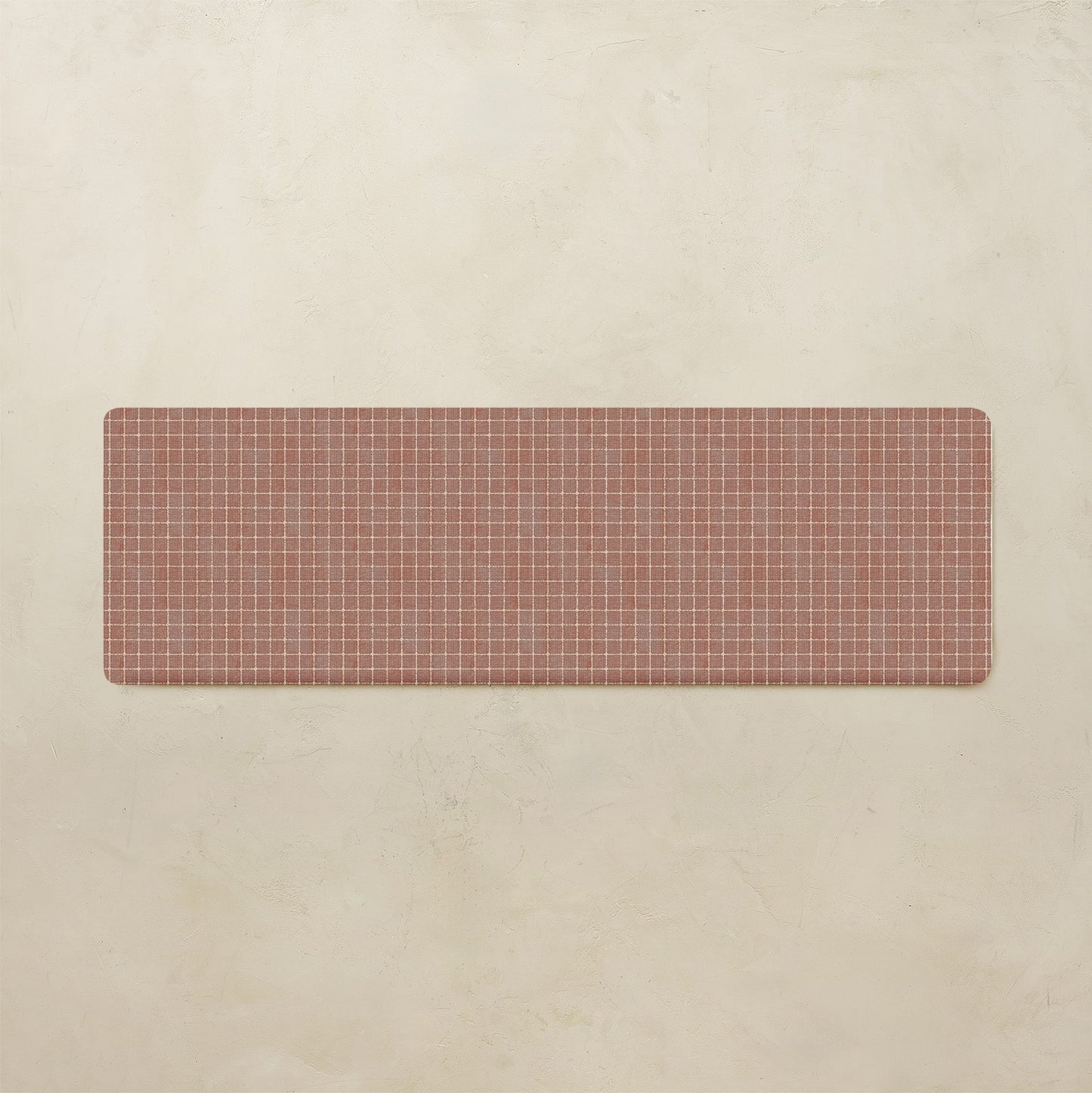 Rectangular kitchen mat with grid pattern on a beige background