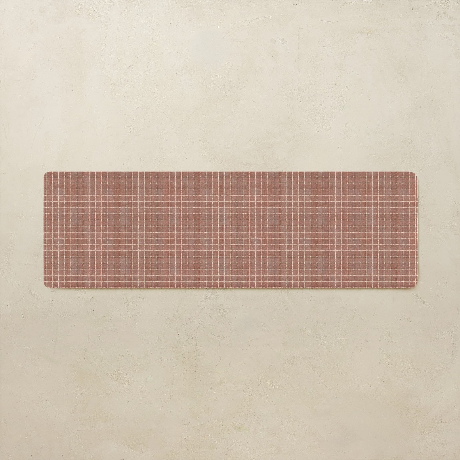 Rectangular kitchen mat with grid pattern on a beige background