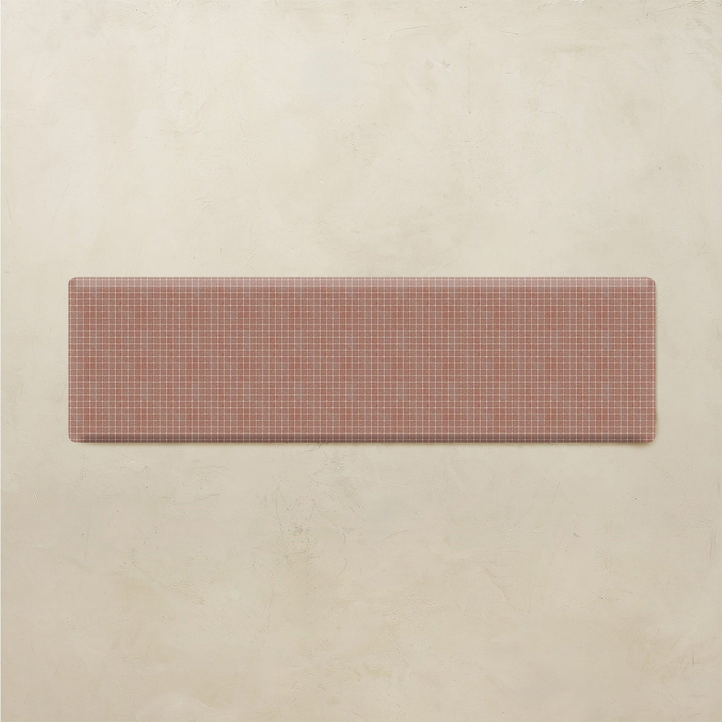 Rectangular kitchen mat with a grid pattern on a beige background