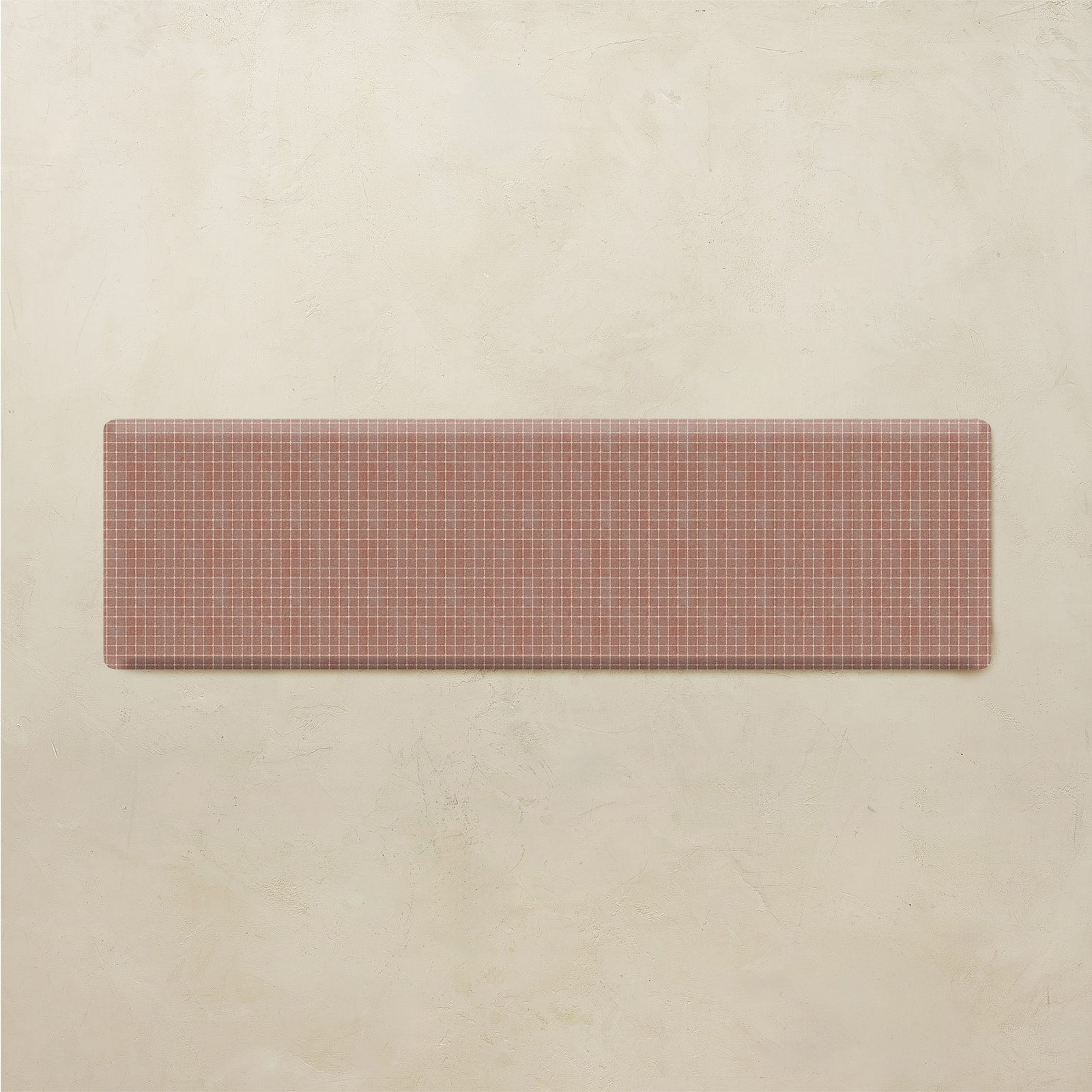 Rectangular kitchen mat with a grid pattern on a beige background