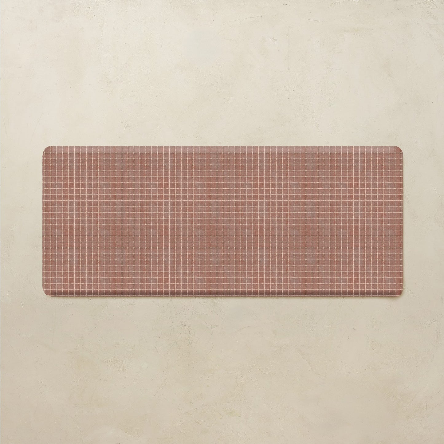Rectangular red and white grid mat on a beige background