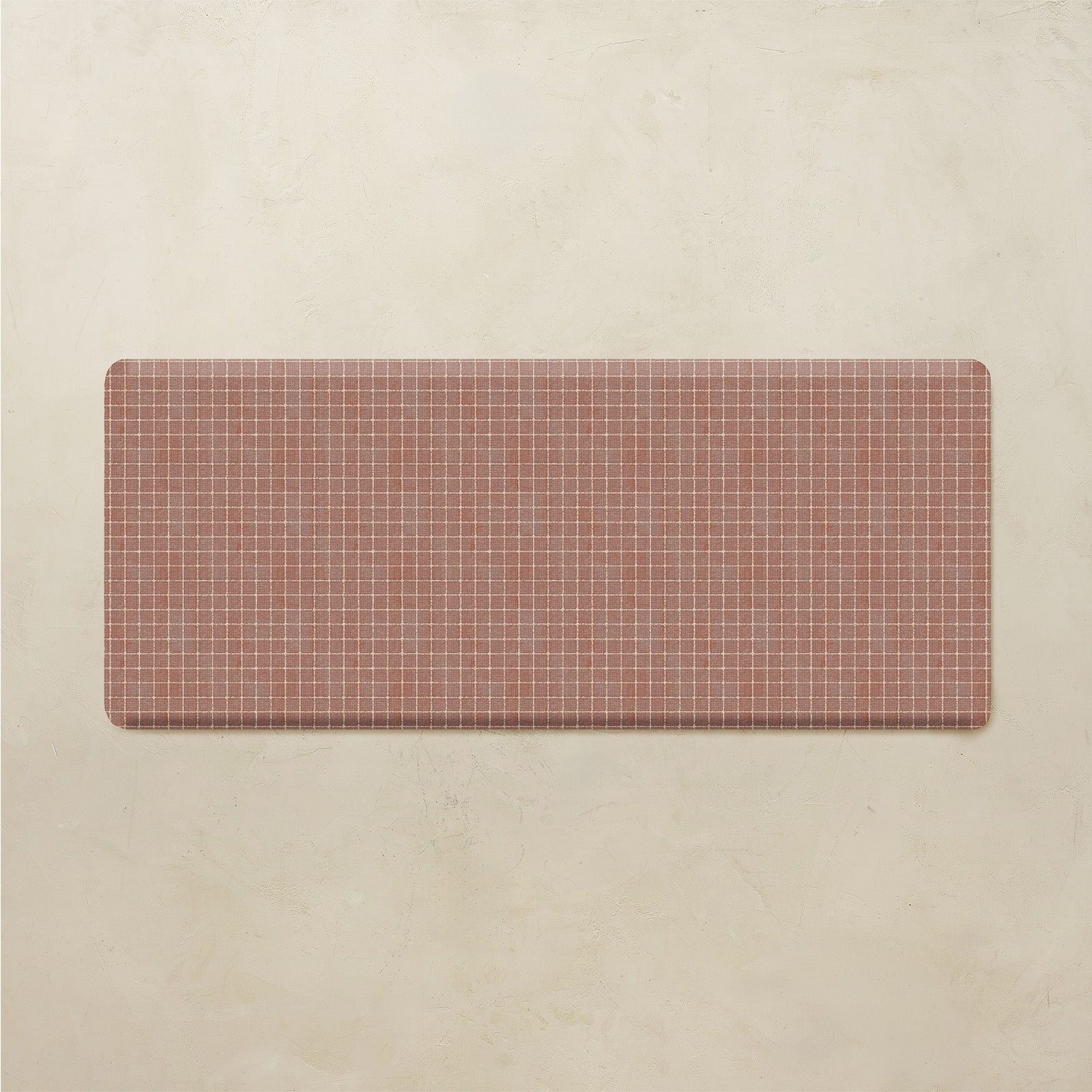 Rectangular red and white grid mat on a beige background