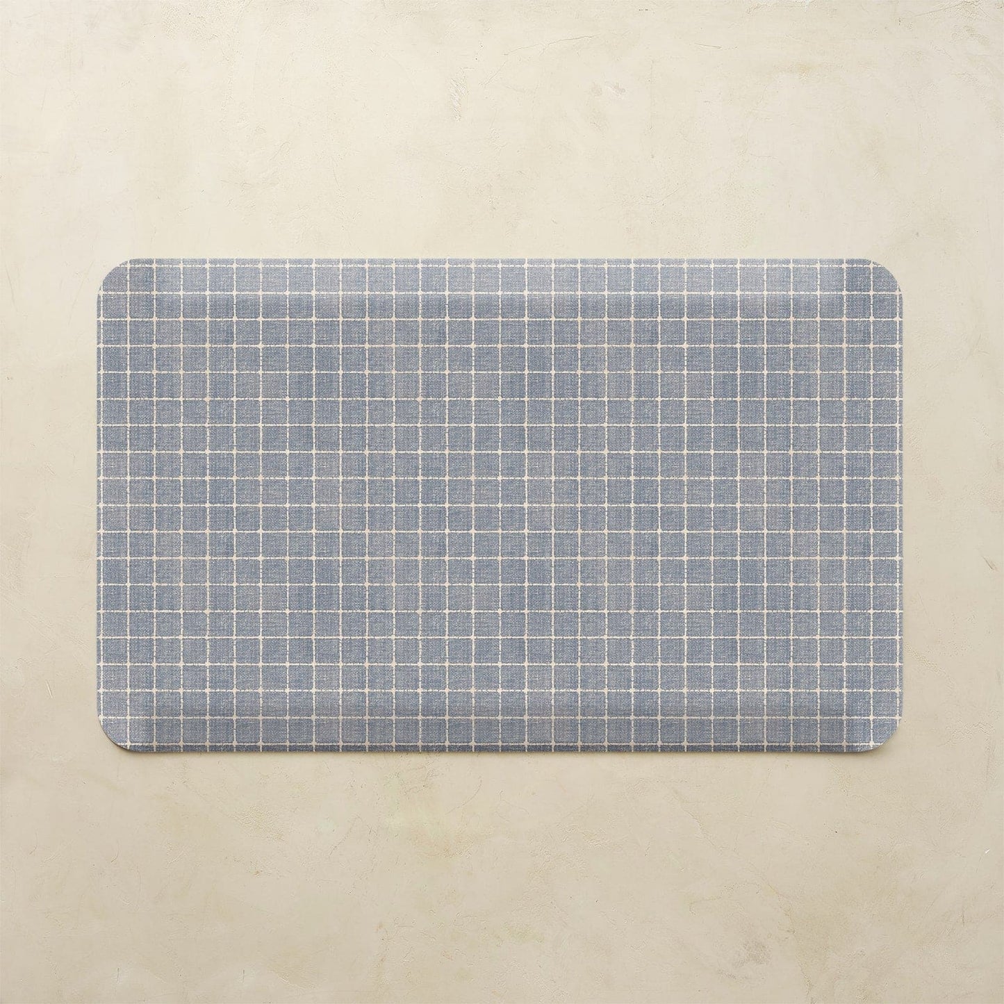 Rectangular placemat with blue grid pattern on a beige background