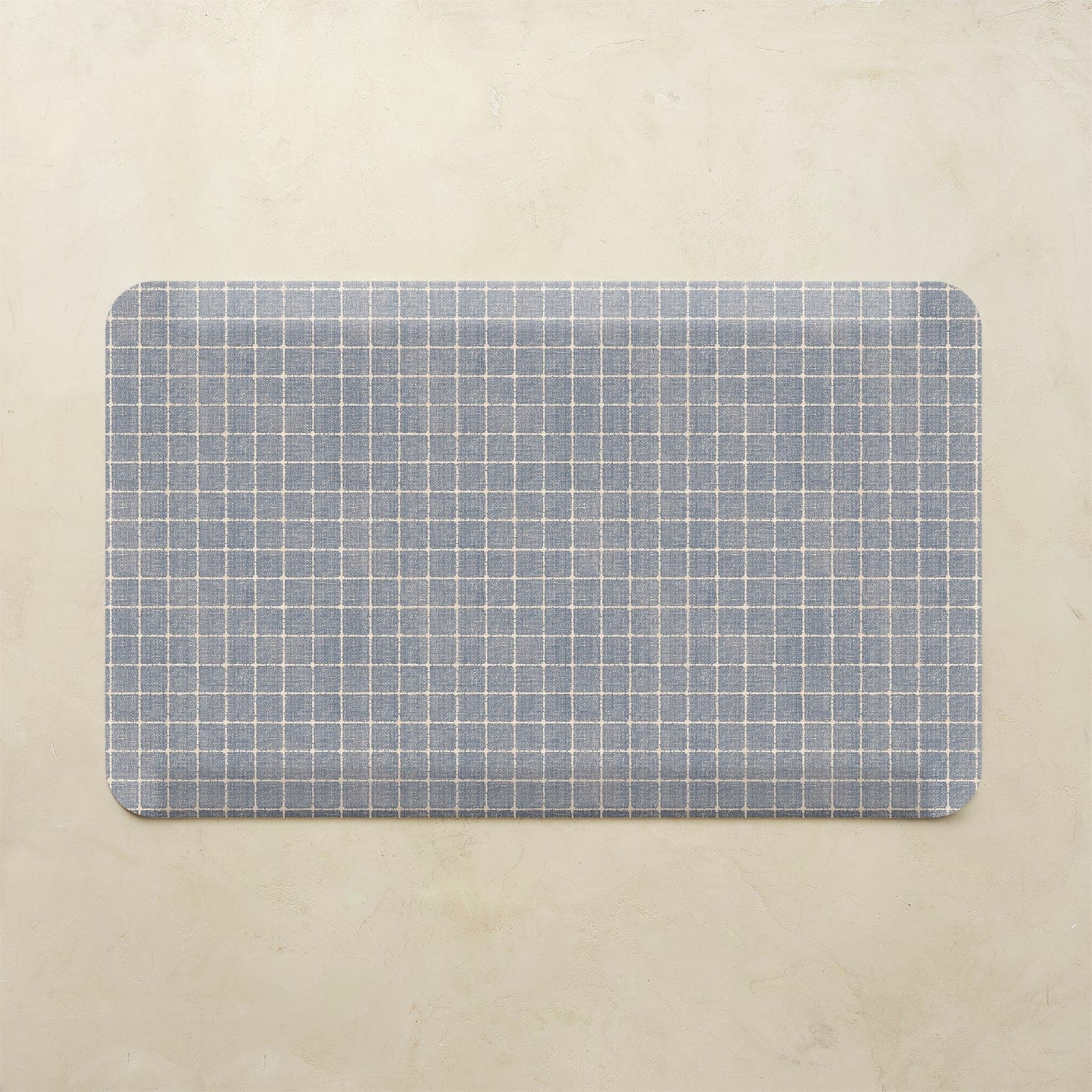 Rectangular placemat with blue grid pattern on a beige background