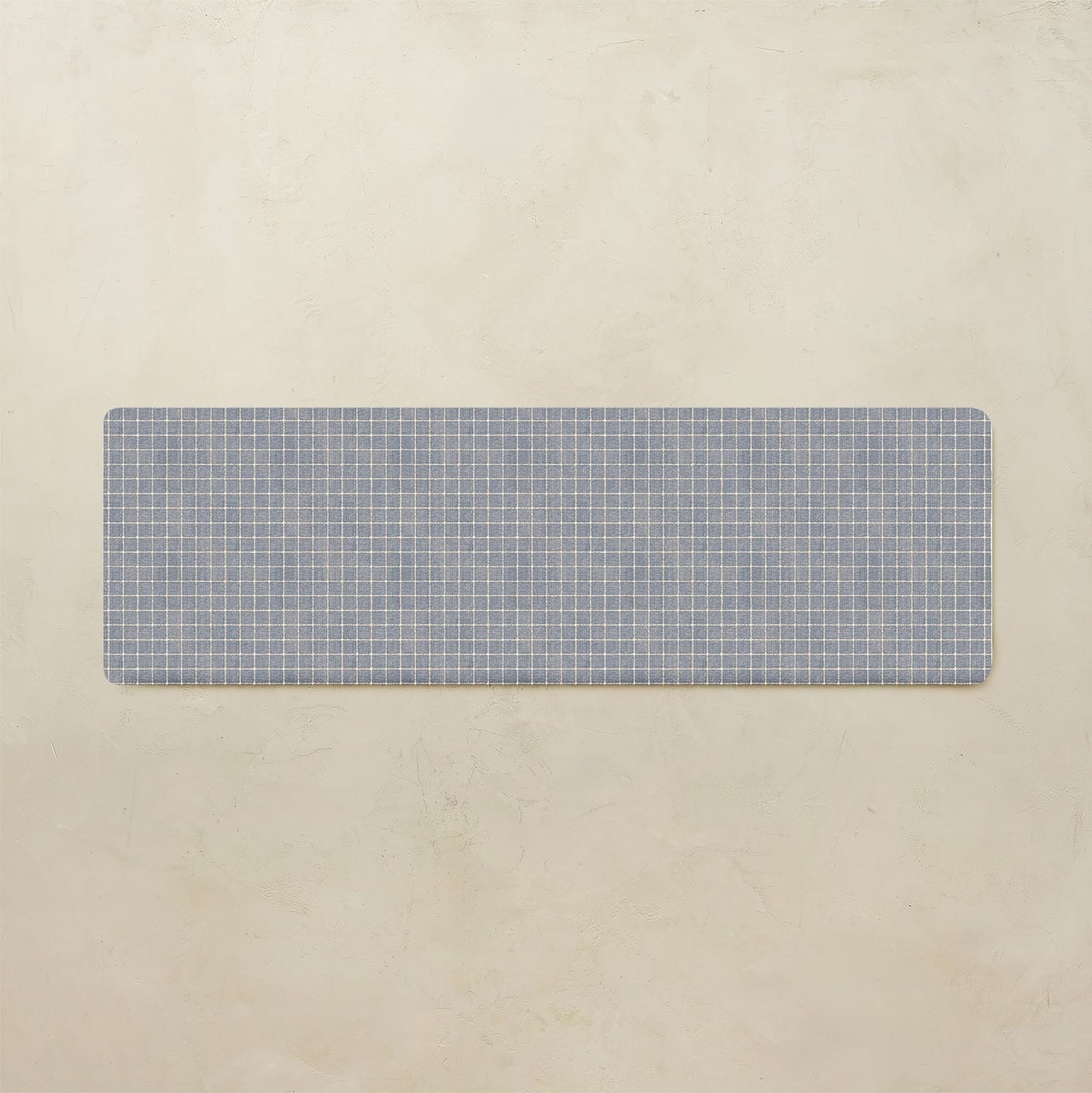 Rectangular blue grid placemat on a beige background