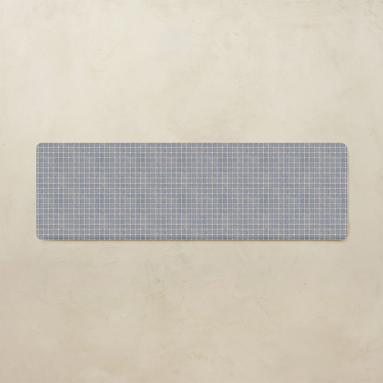 Rectangular blue grid placemat on a beige background