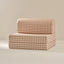 Beige and brown checkered sofa on a beige background