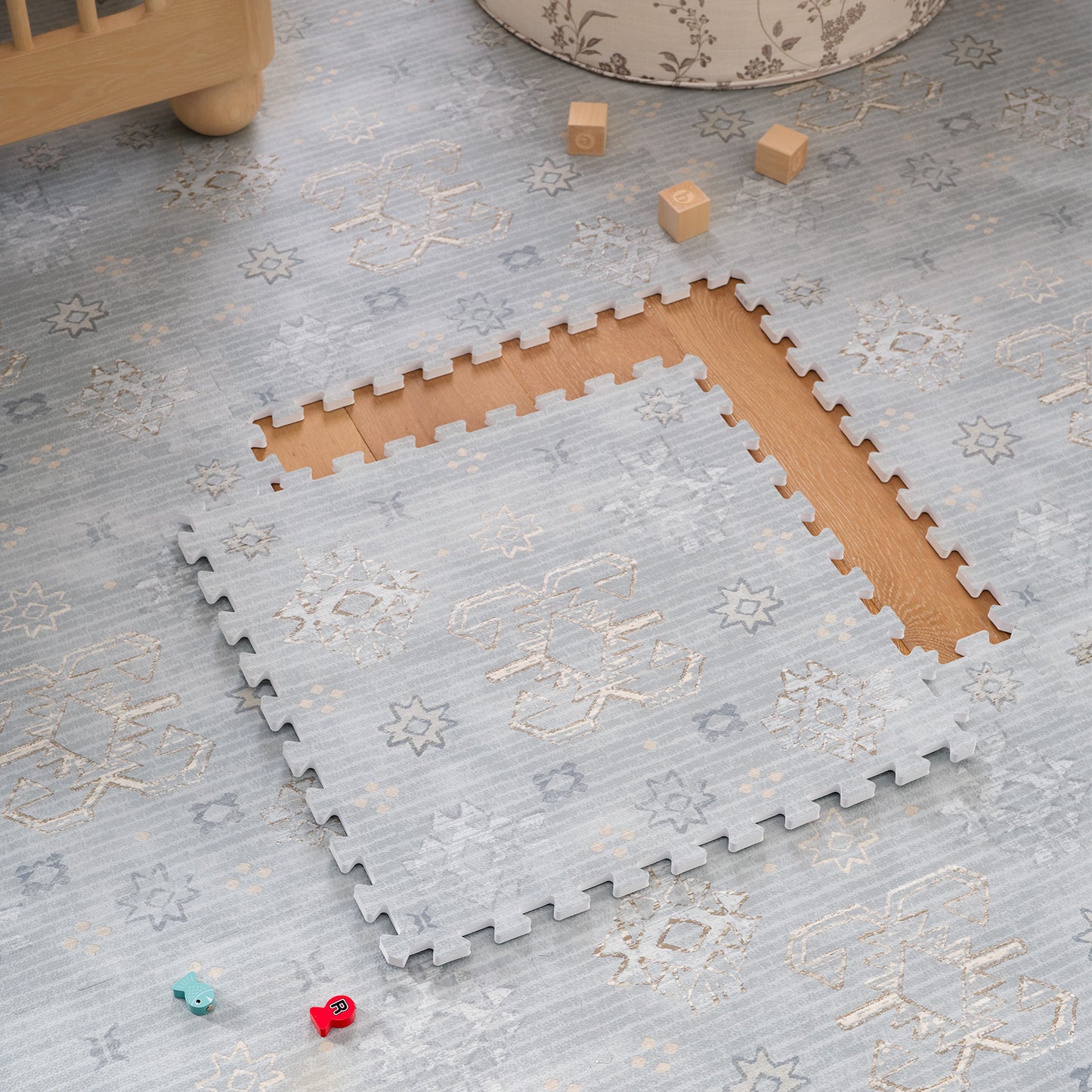 Blue interlocking foam puzzle mat with on a light wood floor