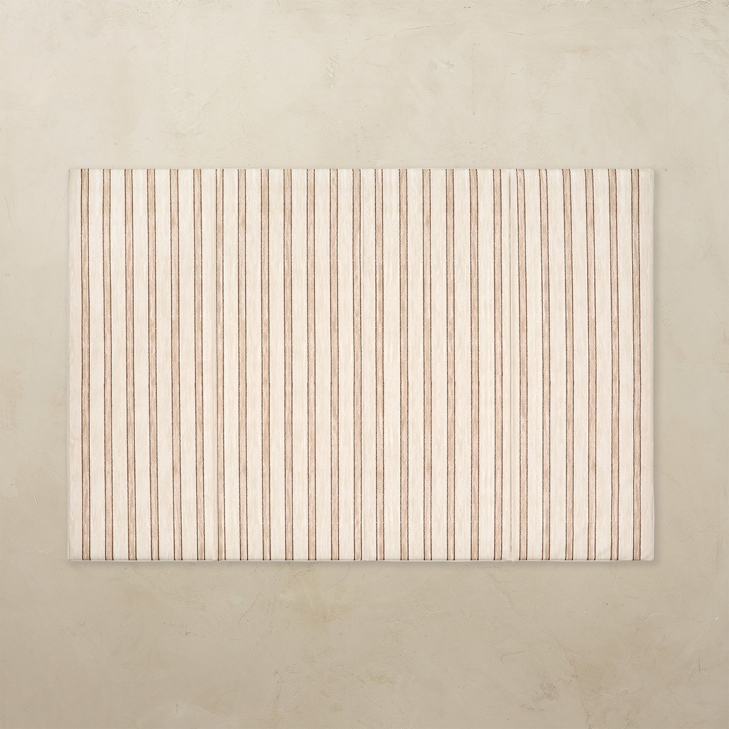 Rectangular tumbling mat with vertical striped pattern on a beige background