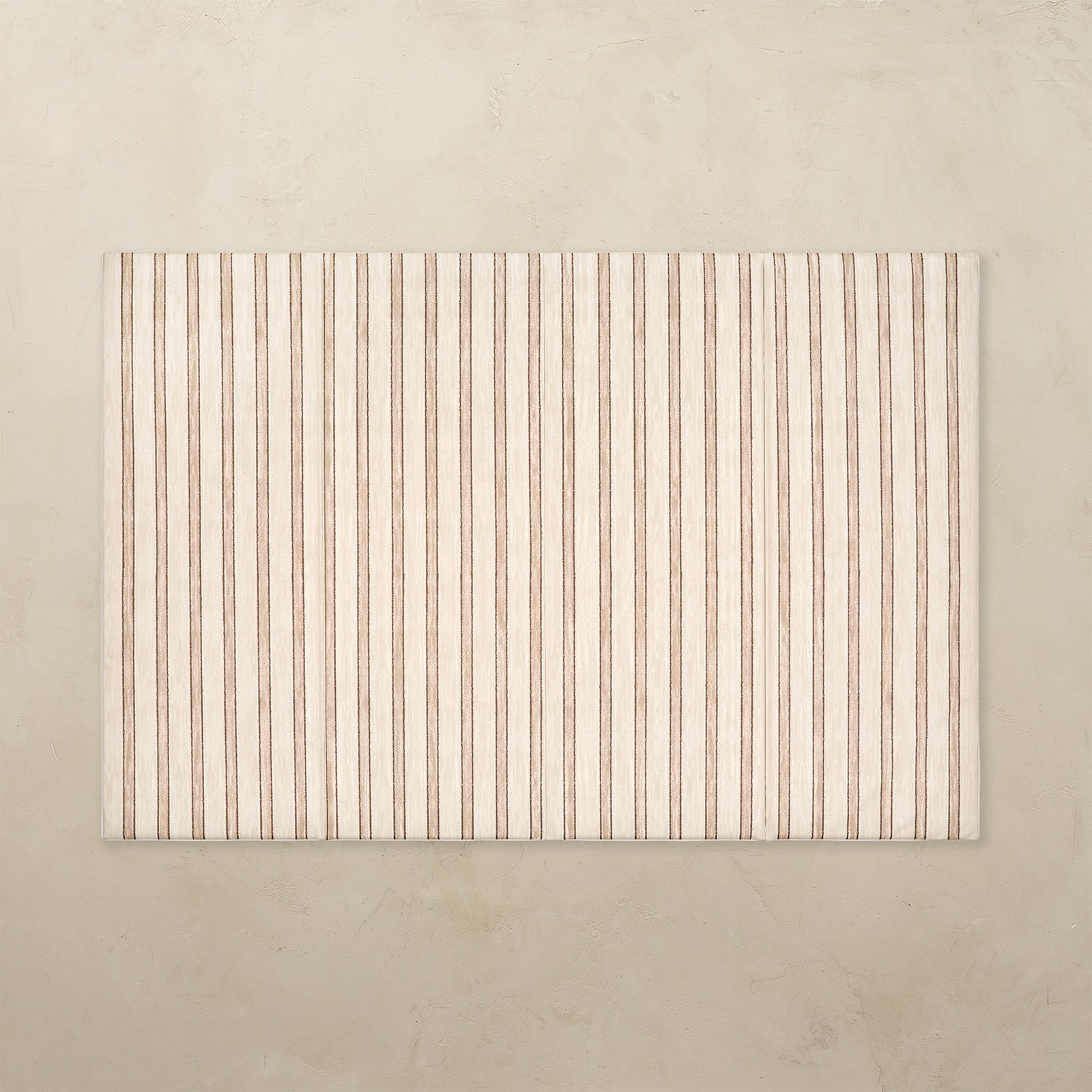 Rectangular tumbling mat with vertical striped pattern on a beige background