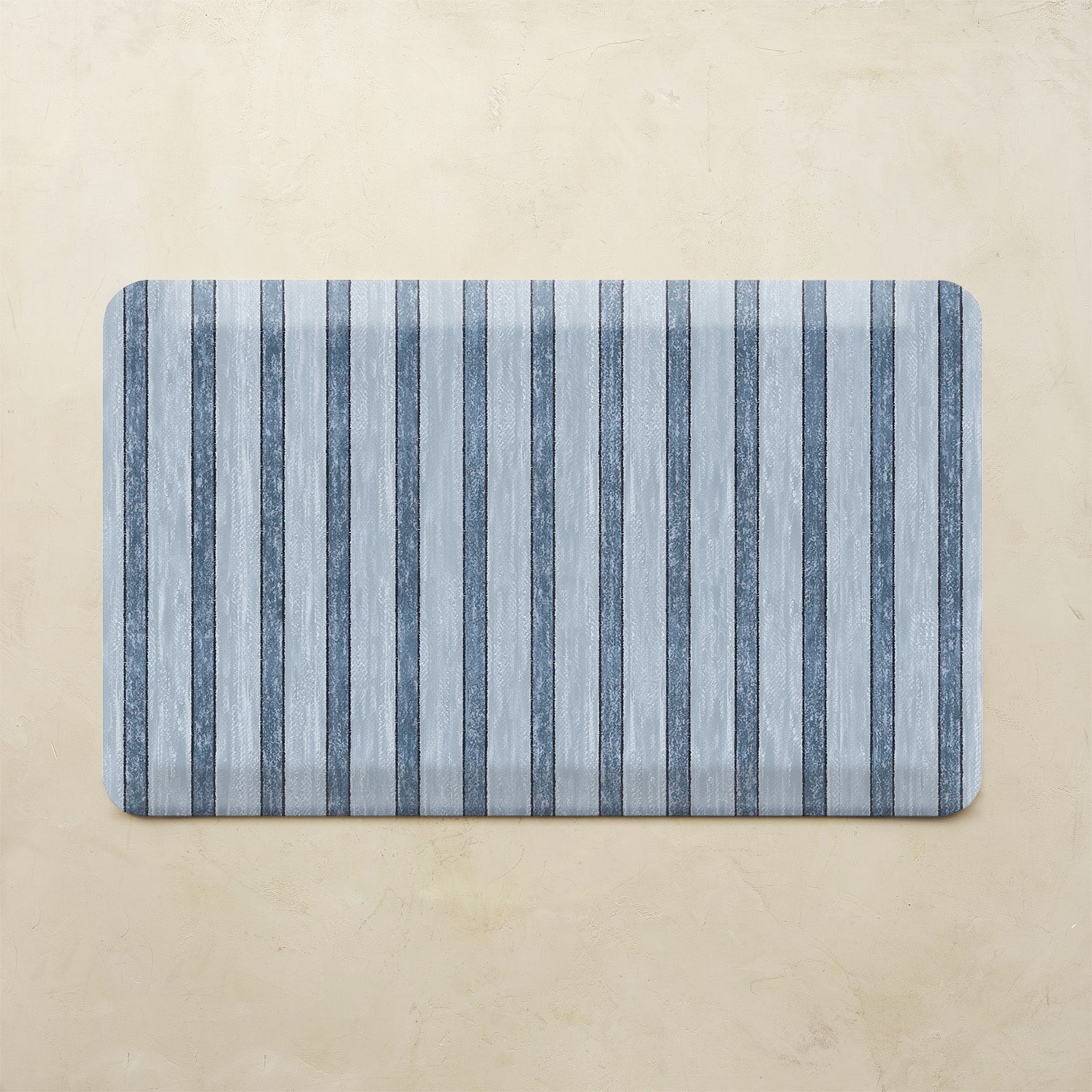 Rectangular mat with blue and gray striped pattern on a beige background