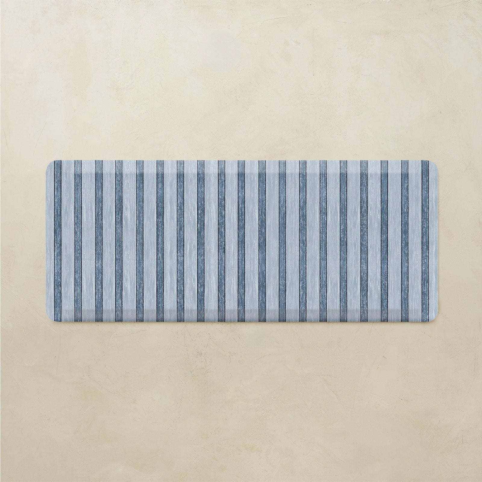 Rectangular mat with blue and gray striped pattern on a beige background