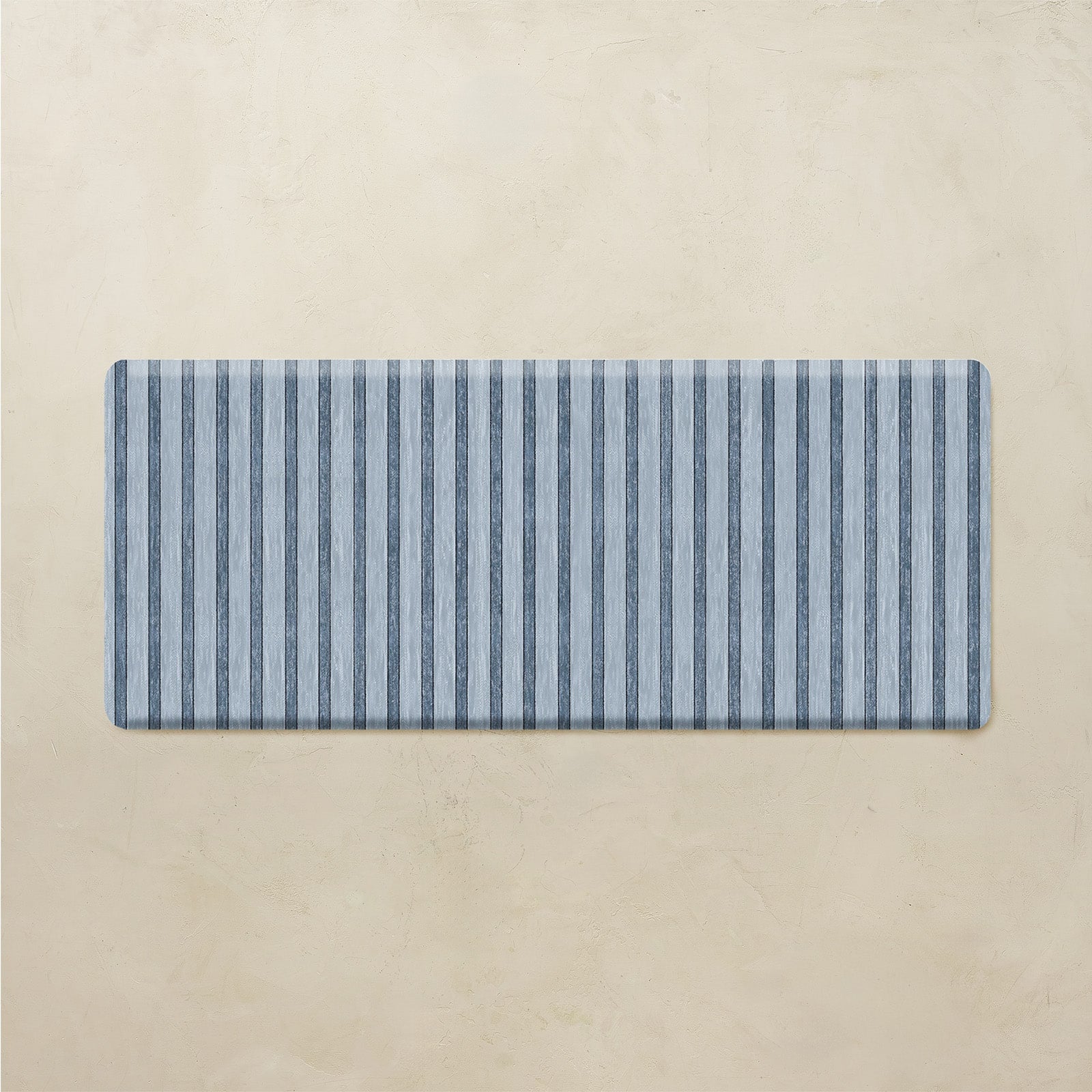 Rectangular blue and white striped mat on a beige background