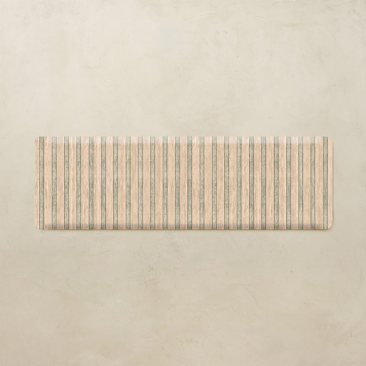 Rectangular kitchen mat with striped pattern on a beige background