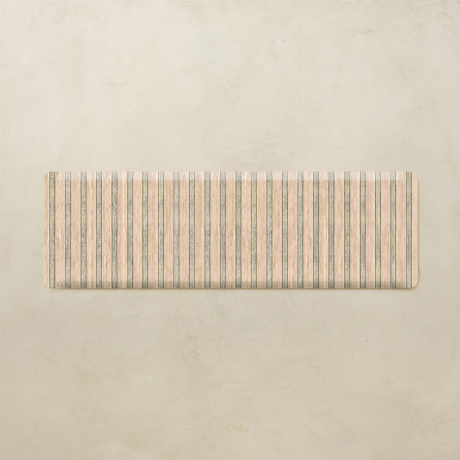 Rectangular kitchen mat with striped pattern on a beige background