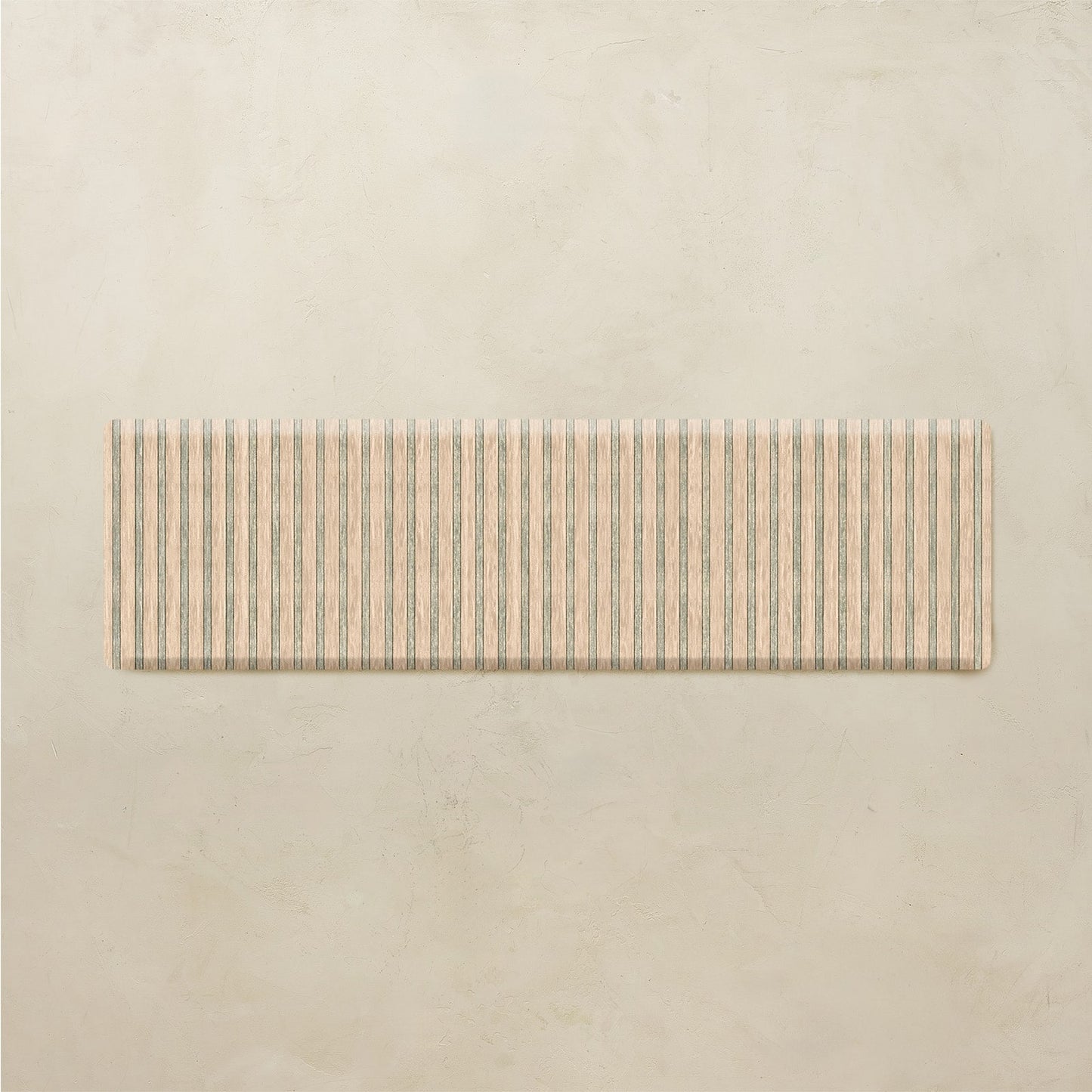 Rectangular kitchen mat with striped pattern on a beige background