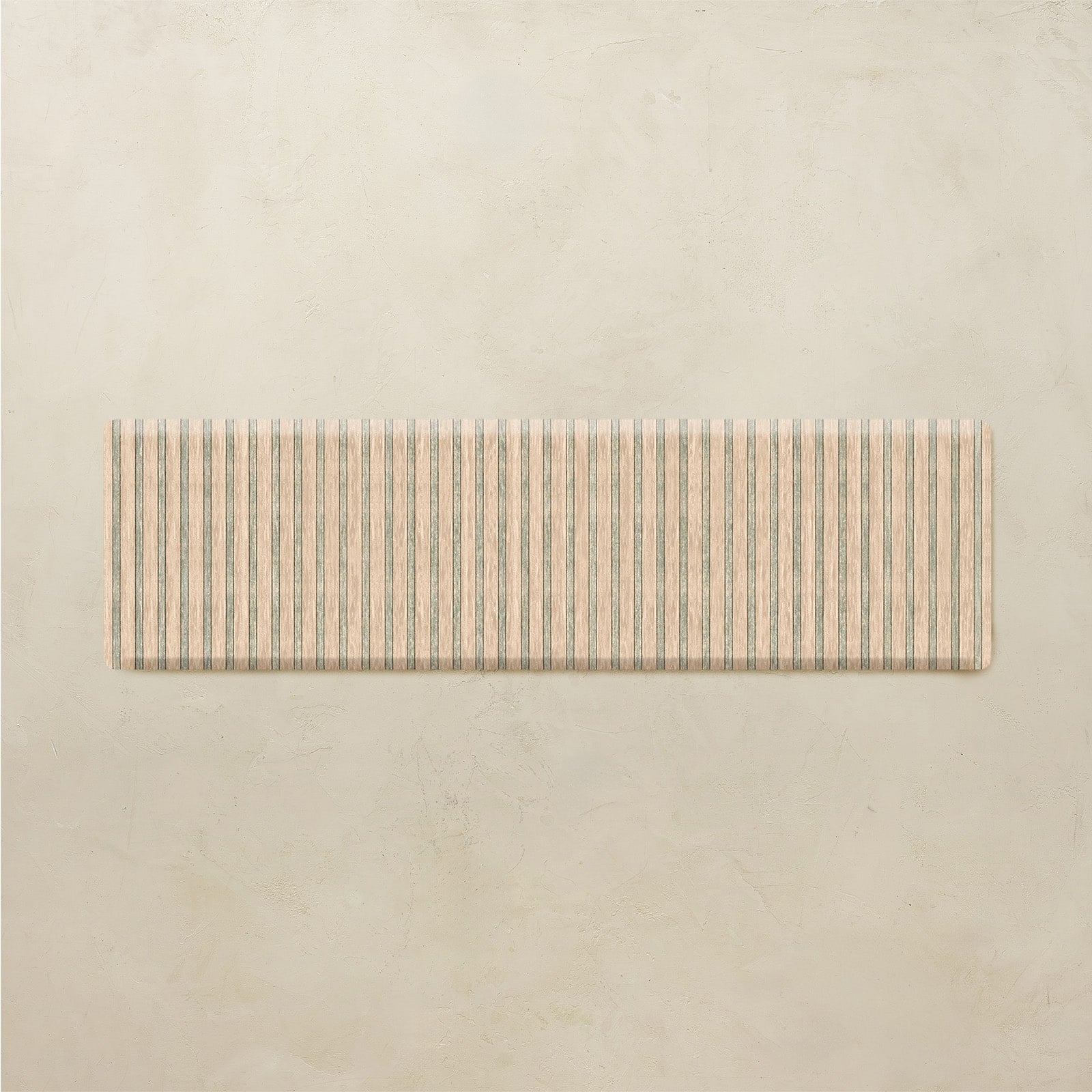 Rectangular kitchen mat with striped pattern on a beige background