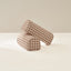 Two cylindrical checkered armrests on a light beige background