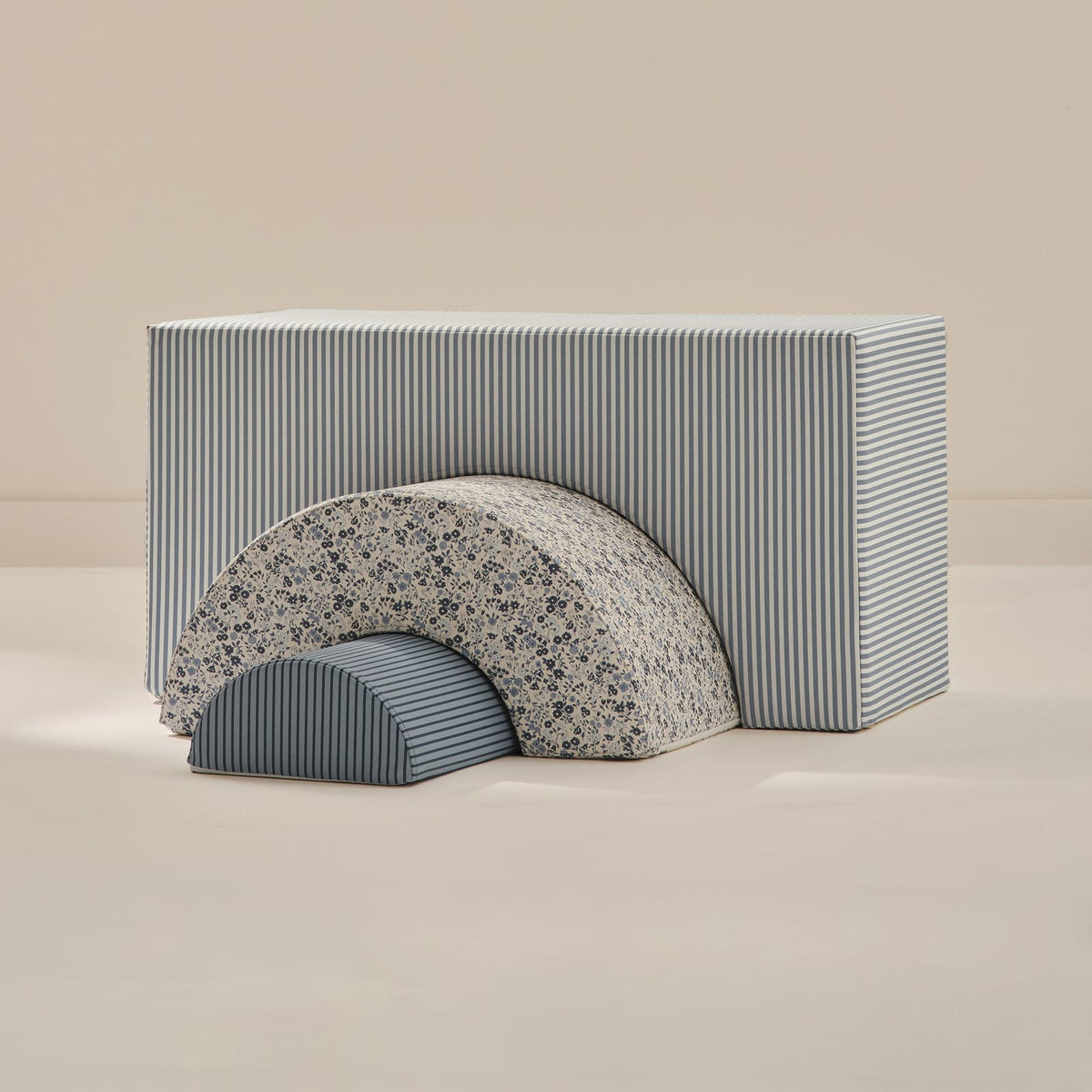 Chambray Arch Set: a large blue and white striped arch block, a blue floral arch and a small navy striped half-round, nested together on a beige background.
