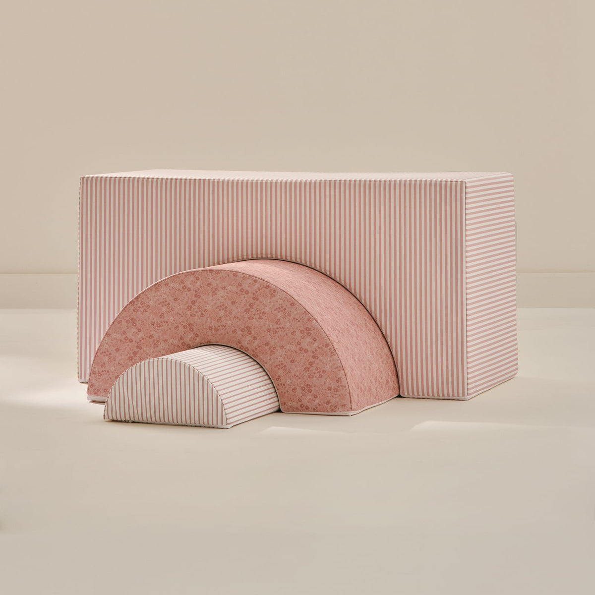 Peony Arch Set: a large pink and white striped arch block, a pink floral arch and a small pink striped half-round, nested together on a beige background.