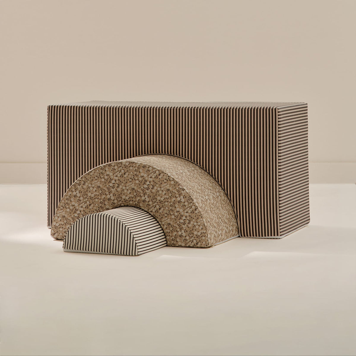 Rye Arch Set: a large brown and cream striped arch block, a tan floral arch and a small brown striped half-round, nested together on a beige background.