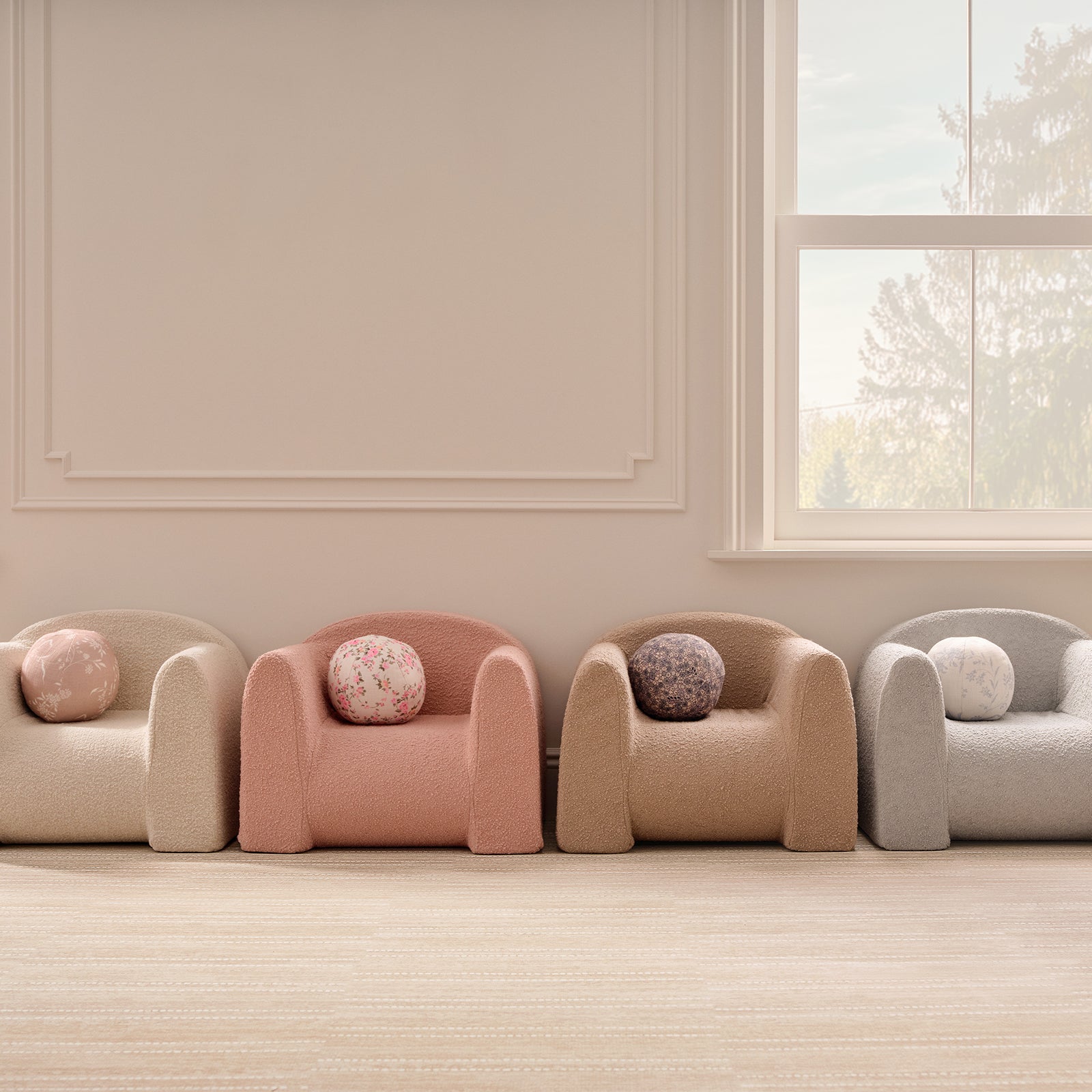 Four armchairs with round cushions in a room with a window and light-colored walls.