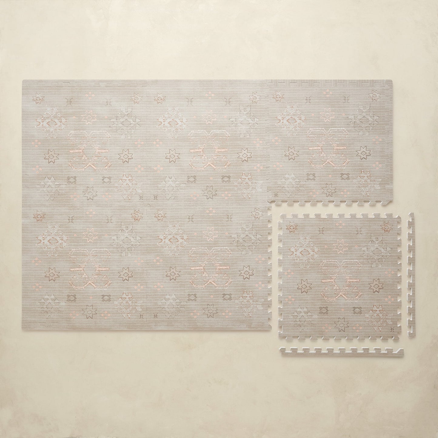 Neutral patterned puzzle play mat on a beige background