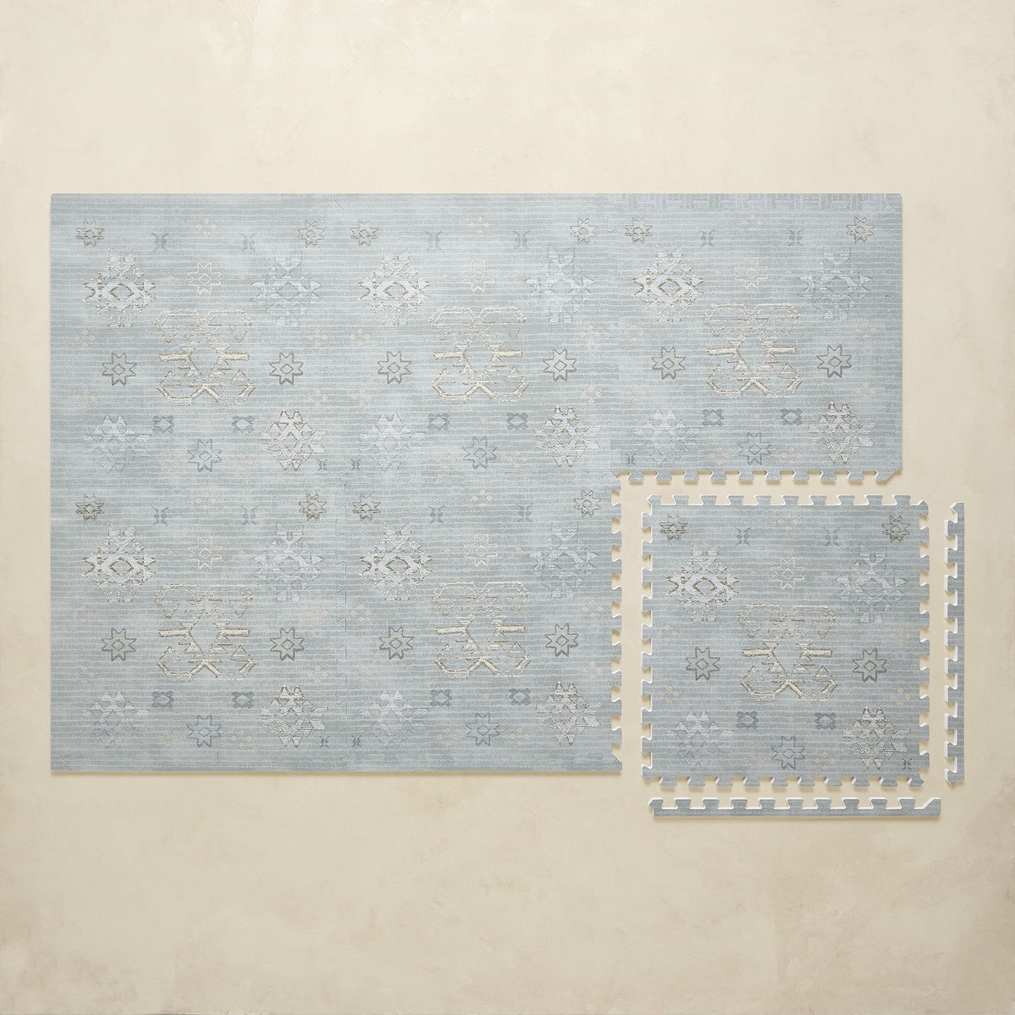 Set of blue patterned puzzle play mat on a beige background
