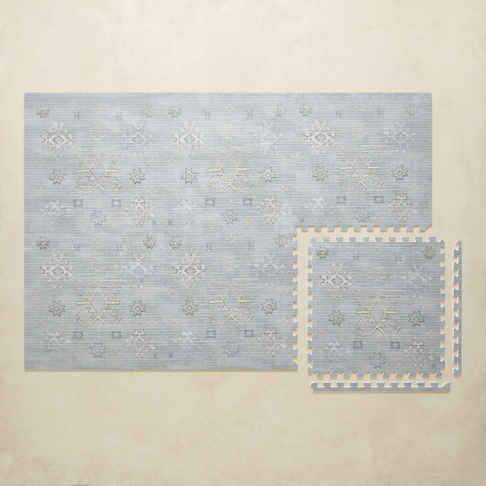 Set of blue patterned puzzle play mat on a beige background