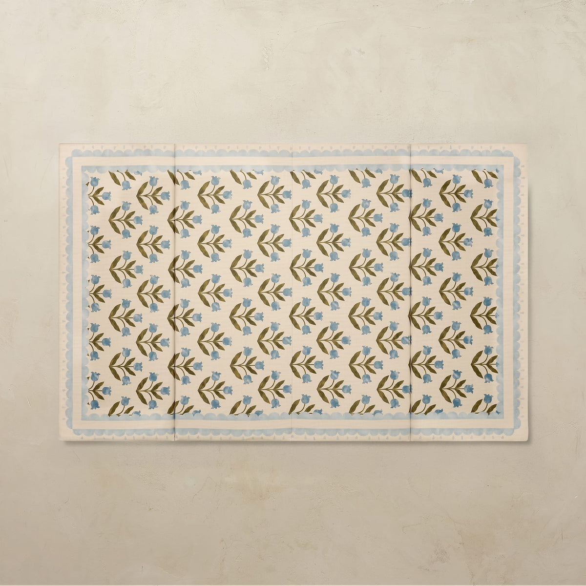 Delilah Cornflower 4x6 tumbling mat with a blue tulip pattern and scalloped light blue border on a cream base