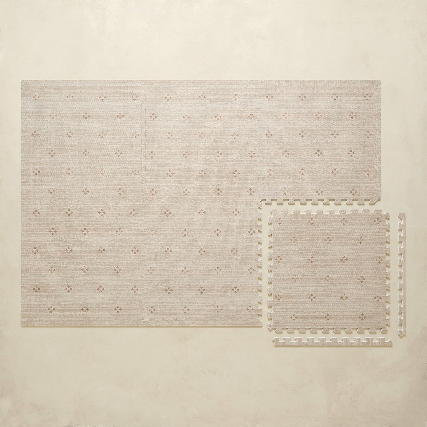 Beige puzzle play mat with a subtle pattern on a beige background