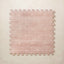 A square interlocking foam play mat tile in dusty rose with a subtle blush diamond dot motif, shown from above on a light beige background.