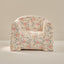 Floral patterned armchair on a neutral background