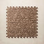 A square interlocking foam play mat with a brown and beige floral pattern, shown from a top-down view against a light beige textured background.