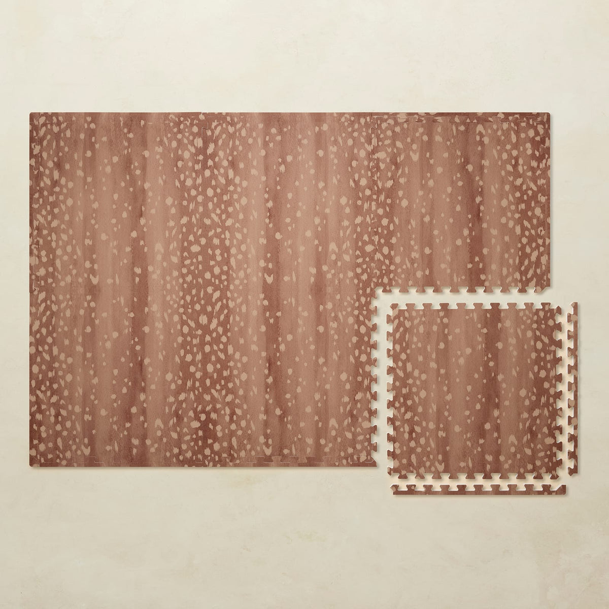 A 4x6 auburn Fawn foam play mat shown beside a single interlocking tile to compare sizes, photographed from above on a beige background.