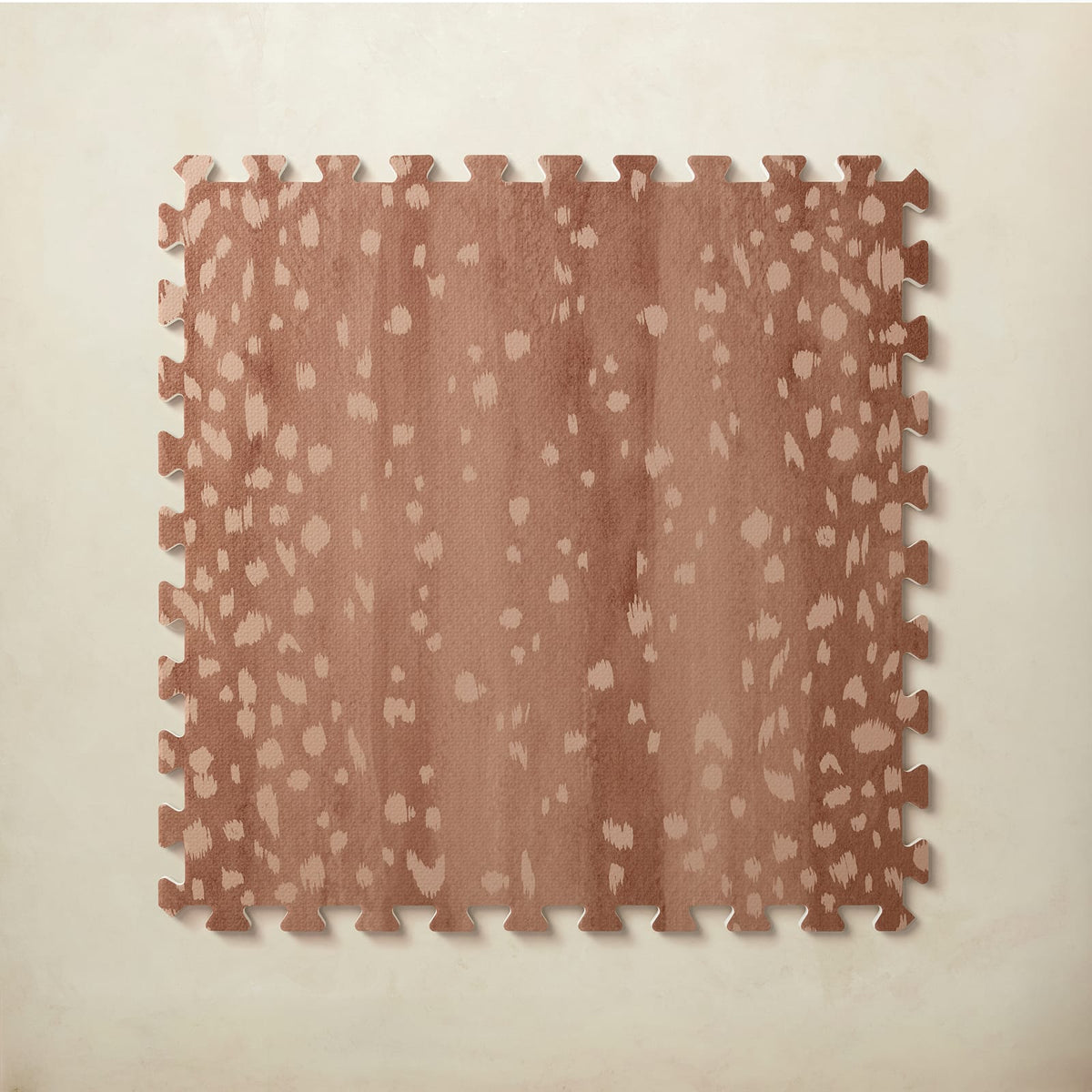 A square interlocking foam play mat tile in warm auburn with scattered blush fawn spots, shown from above on a light beige background.