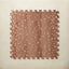 A square interlocking foam play mat tile in warm auburn with scattered blush fawn spots, shown from above on a light beige background.