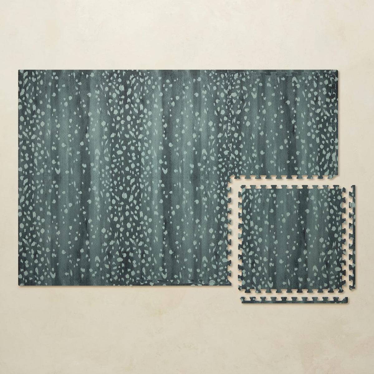 A 4x6 deep turquoise Fawn foam play mat shown beside a single interlocking tile to compare sizes, photographed from above on a beige background.