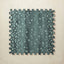 A square interlocking foam play mat tile in deep turquoise with scattered pale aqua fawn spots, shown from above on a light beige background.