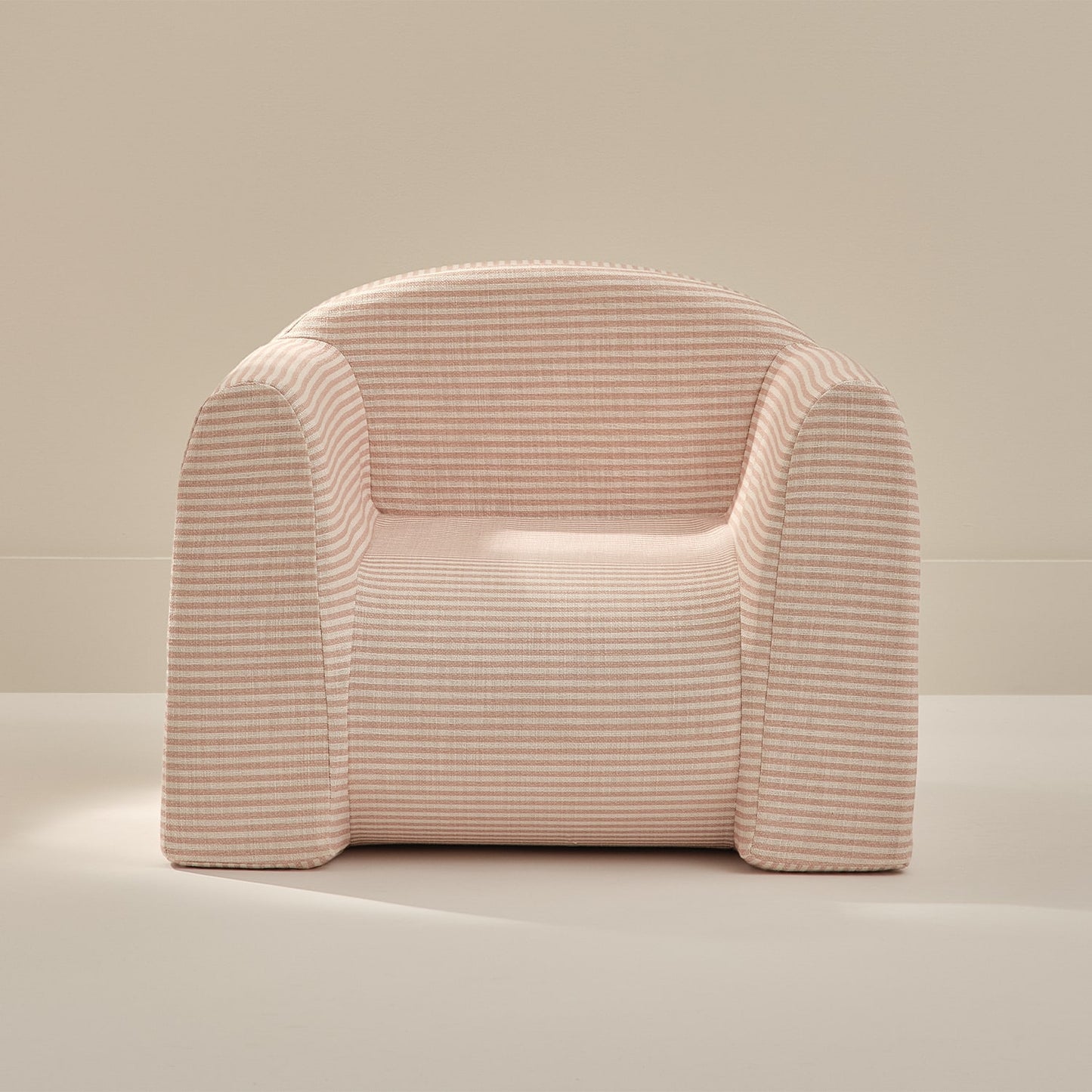Pink textured armchair on a neutral background