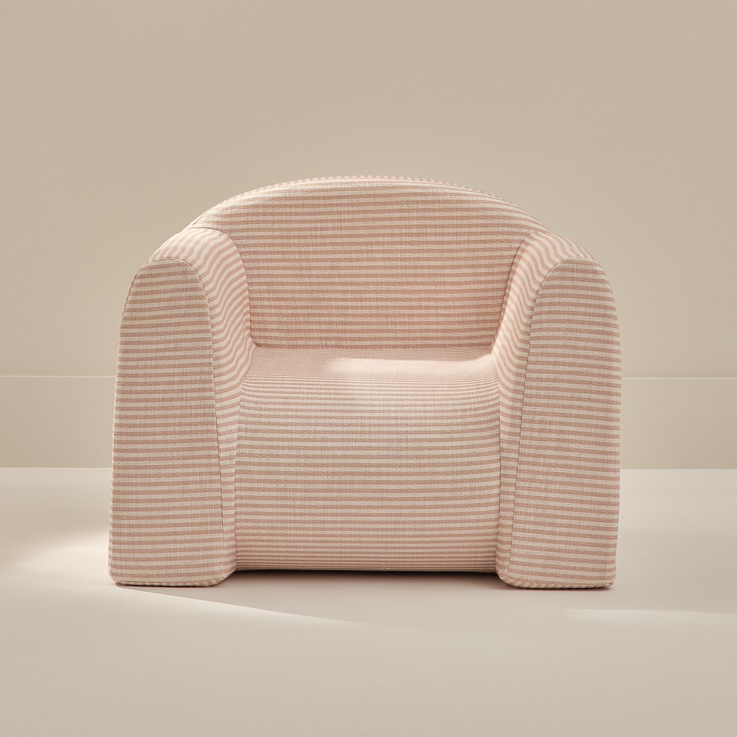Pink textured armchair on a neutral background